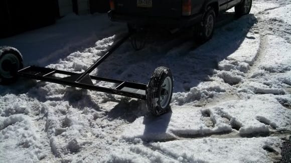 Here's the tow dolly me and my buddy built from scratch.  It was the ultimate design of lightweight and compactness, yet exceptionally strong. Notice I speak of it in past tense, due to the fact that some idiot ran it over while I was going about 35 mph. It got a little mangled, so I had to leave it while we went to get the truck so we could through it in the bed. Then someone stole it! What a day.