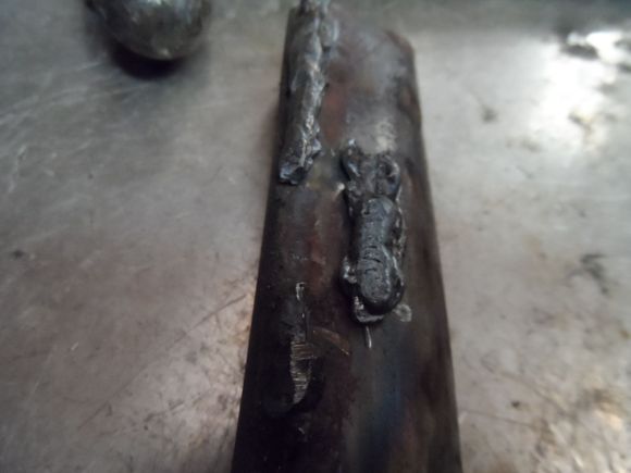 I broke this piece off with a pair of pliers. That person must have had the welder on bubblegum settings. Extra cold/No penetration