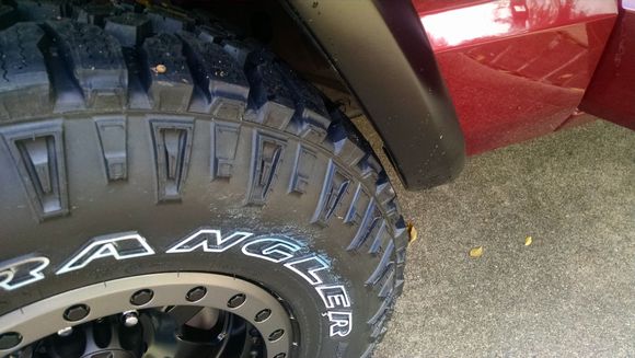 passenger front wheel.  front of fender