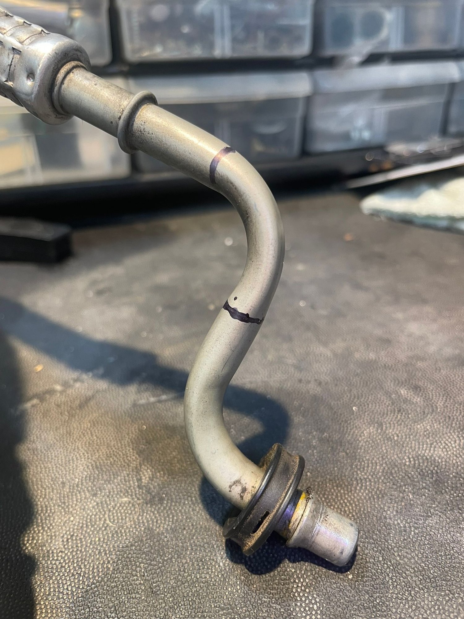 Cut the return line pipe where you see the 2 black lines. The new cooler is plumbed in between these 2 points. The stub goes into the lower radiator port.