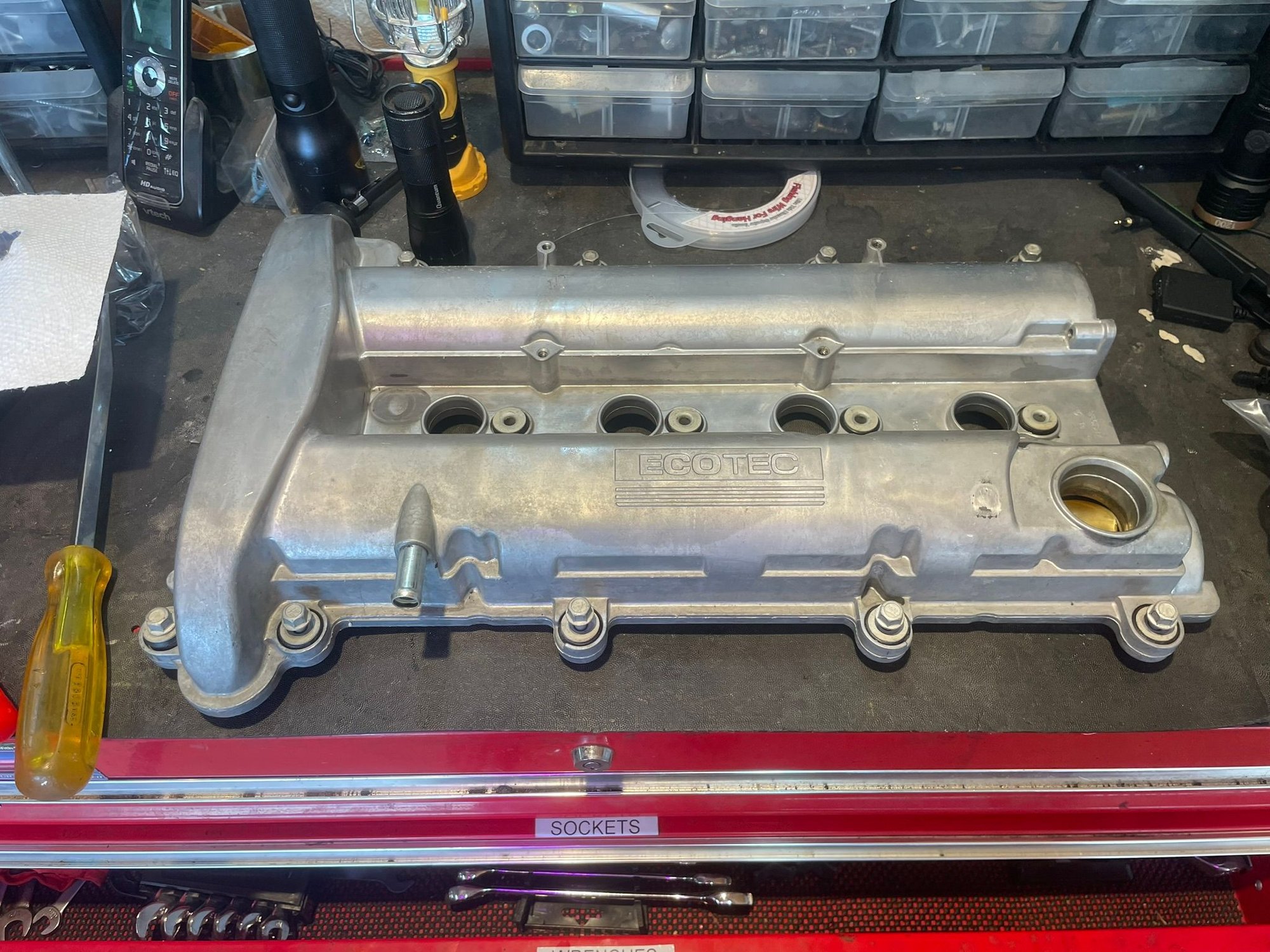 Clean up the valve cover, install a new gasket and the 4 zip ties for the wiring harness.