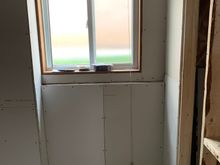 Behind the toilet wall