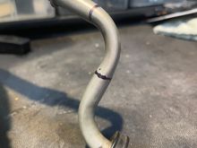 Cut the return line pipe where you see the 2 black lines. The new cooler is plumbed in between these 2 points. The stub goes into the lower radiator port.