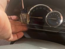 Remove the 2 Phillips screws above the instrument cluster.