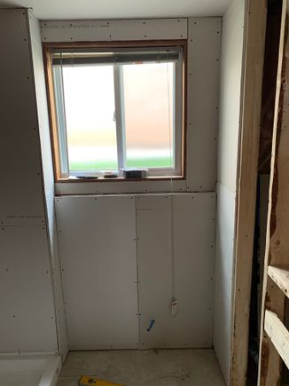 Behind the toilet wall