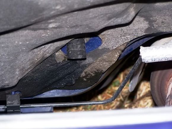 That black hose sticking out of the firewall to the passengers side of the exhaust flex pipe, this photo the air cleaner box is removed