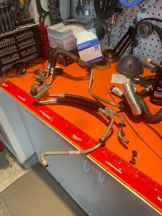 The old and new GM cooler lines before modification. The shorter line must be cut to allow the hoses to be installed. The part that goes into the radiator will be a short stub with a 90. Use 2 clamps on each hose.