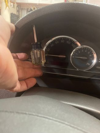 Remove the 2 Phillips screws above the instrument cluster.