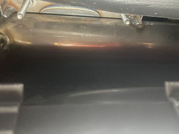 Looking up through the glove box opening you will see 2 studs. Remove the nuts from each stud using the 11 mm socket and ratchet.