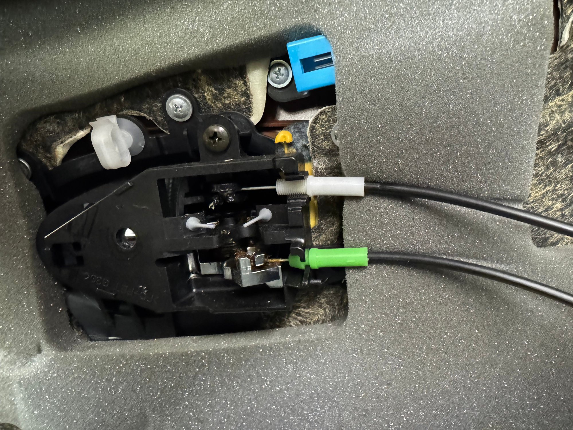 Photo of cables attaching to back side of door panel handle assembly. 