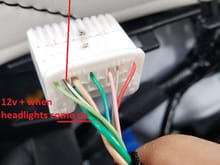 Window control harness/plug.  Thicker green wire is 12v + when headlights are on.  Thinner white wire with black stripe is ground.