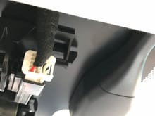 Its of 2 white clips looking up to right of rearview mirror.   Also there are 3 wires beneath the black rain sensor, yellow, green, black with white stripe
