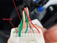 The thicker green wire on the side of the connector is 12v + when the headlights are turned on.