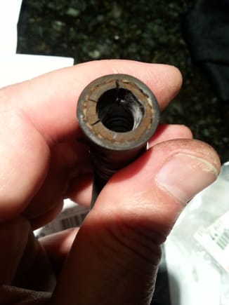 This image depicts cracking on end of the hose connecting to the check valve on brake vacuum booster. (!!!) After 18 years,  both ends of hose were rock hard and turned easily on fittings...The hose clamps had lost some tension and were replaced.