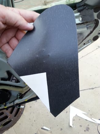 DEI barrier  material shown with adhesive backing removed save for the area that will cover ECU (to allow future access.