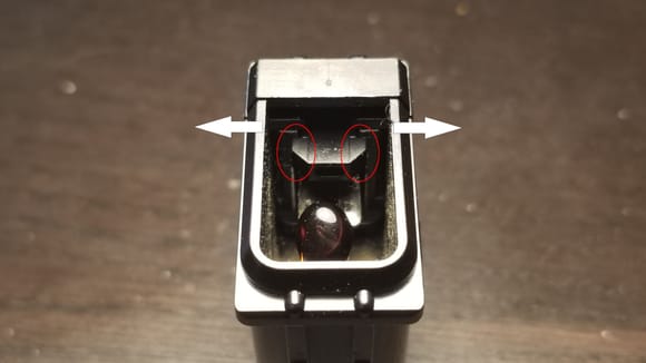 Press on the sides until the clip marked in red will get released.