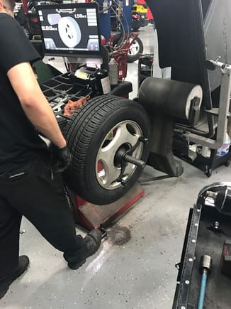 Professional balancing equipment...The black drum shaped device on the right will detect tire out of roundness...if slight accommodate in the balancing...
