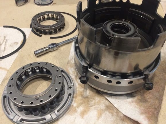 Here is the direct clutch, or 3rd gear, sitting in the overdrive piston. The 4 holes between the bolts are for pressure control to different pistons to engage certain clutches. You need to have it like this to pop the piston out with air pressure in the direct clutch port. To the left is the actual piston and return spring.