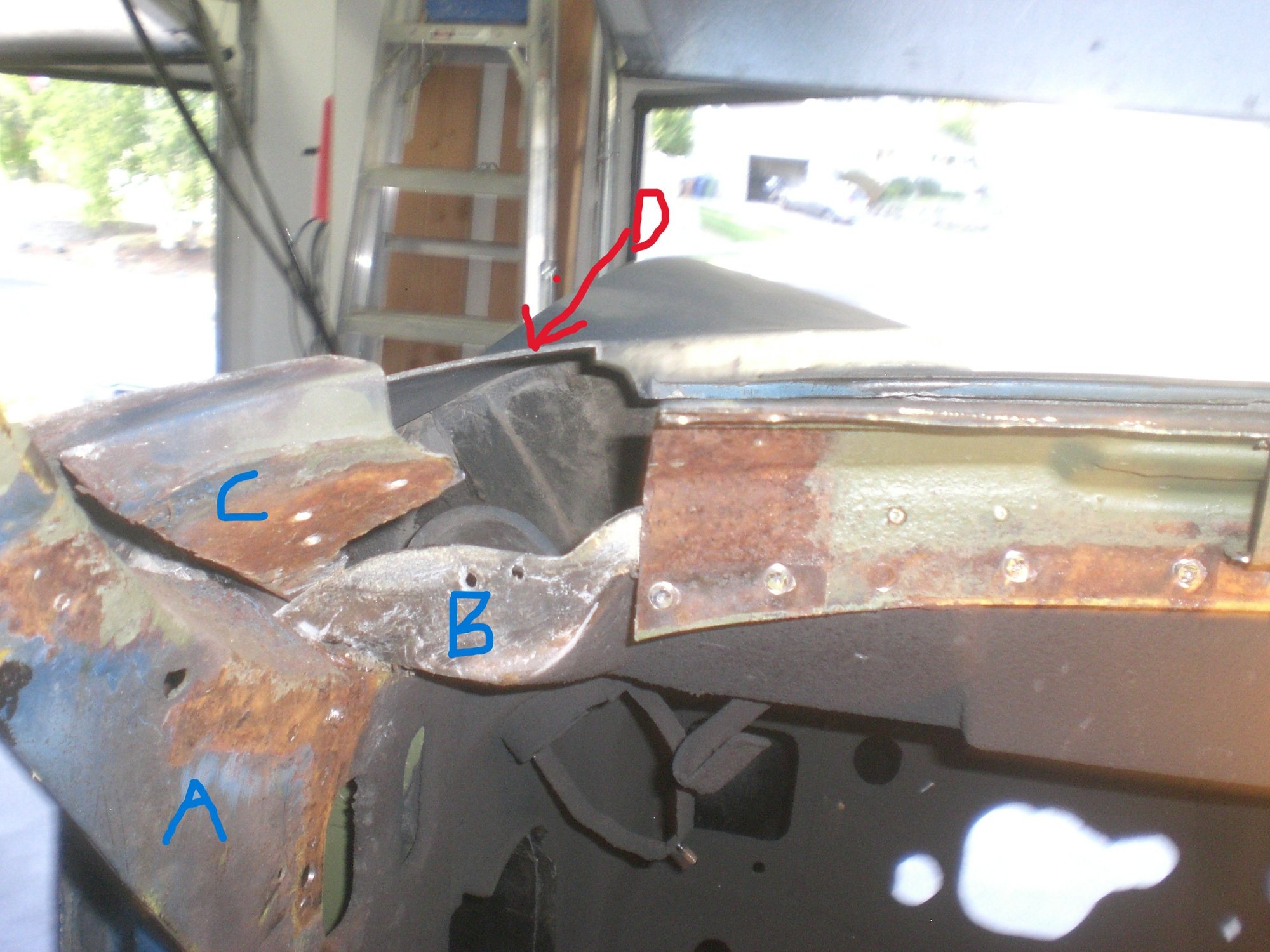This shot was taken after the inner and outer metal corners were removed and the fender cut made.  It shows the bonding support piece (C) and the 3 rivet holes, the hinge pillar where it merges into the windshield side frame (A) and the rear vertical portion of the wiper trough (B).  You can see the two rivet holes where B was riveted to the metal outer corner piece.