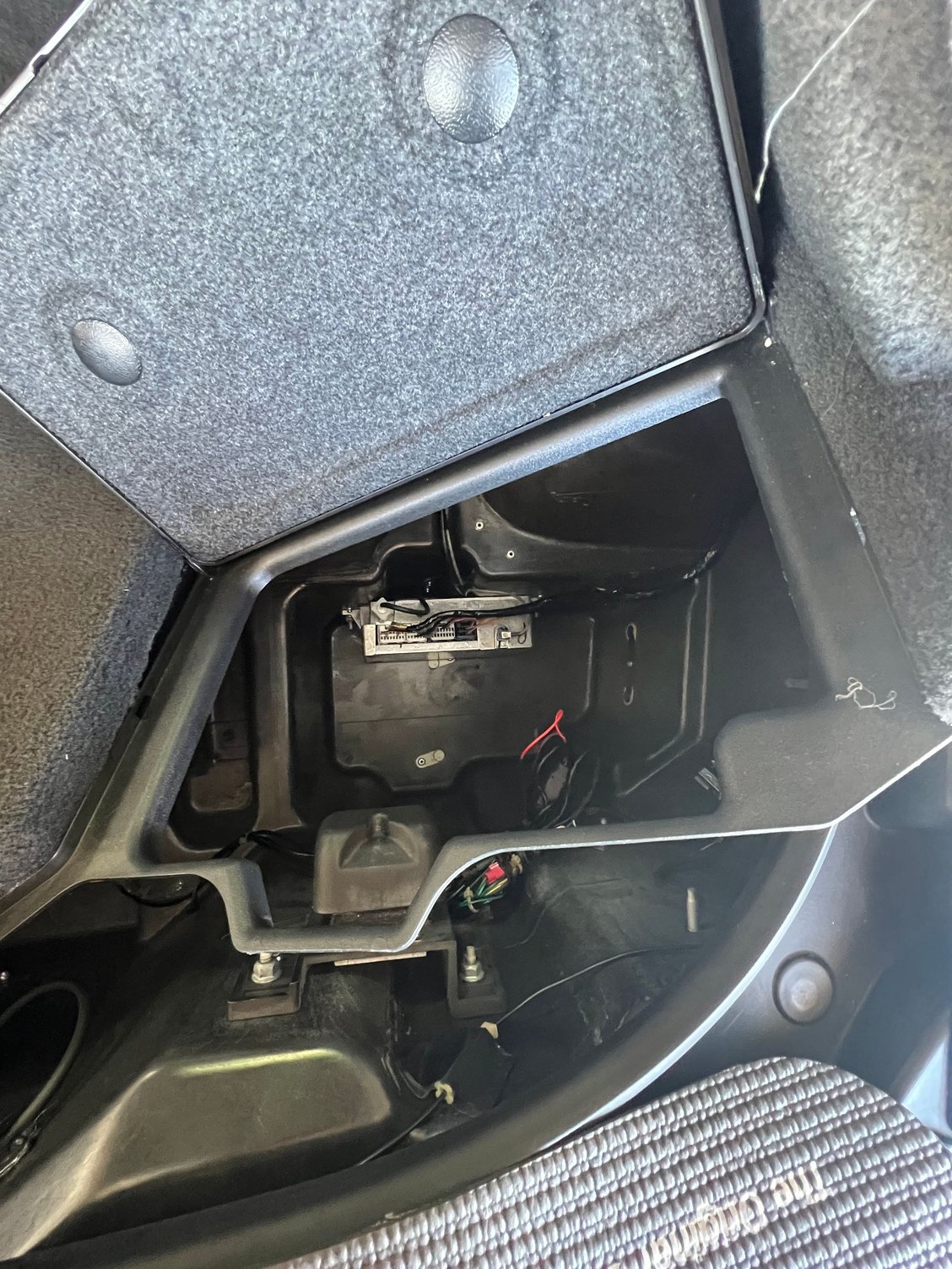 VCIM right rear storage compartment…comm lines on connector to the right…tan and tan/black