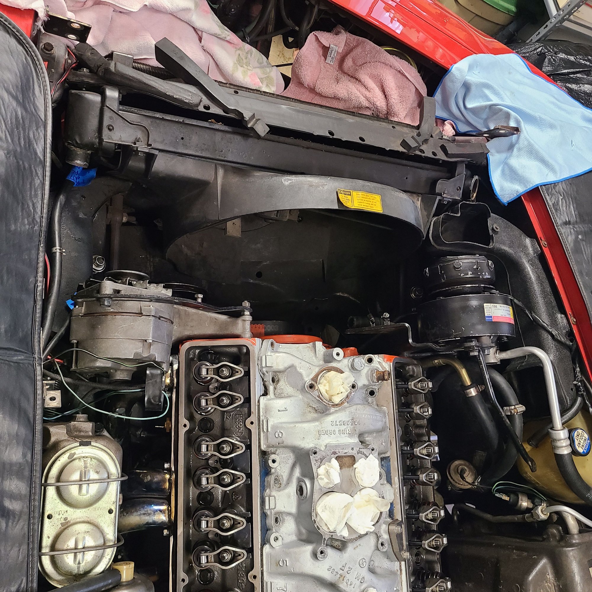 Your situation may look different as I am swapping a cam.  Here is what I have this AM. Radiator needs to come out and A/C condenser needs to tilt forward a bit to clear the cam as it comes out.  I get the shroud out next.