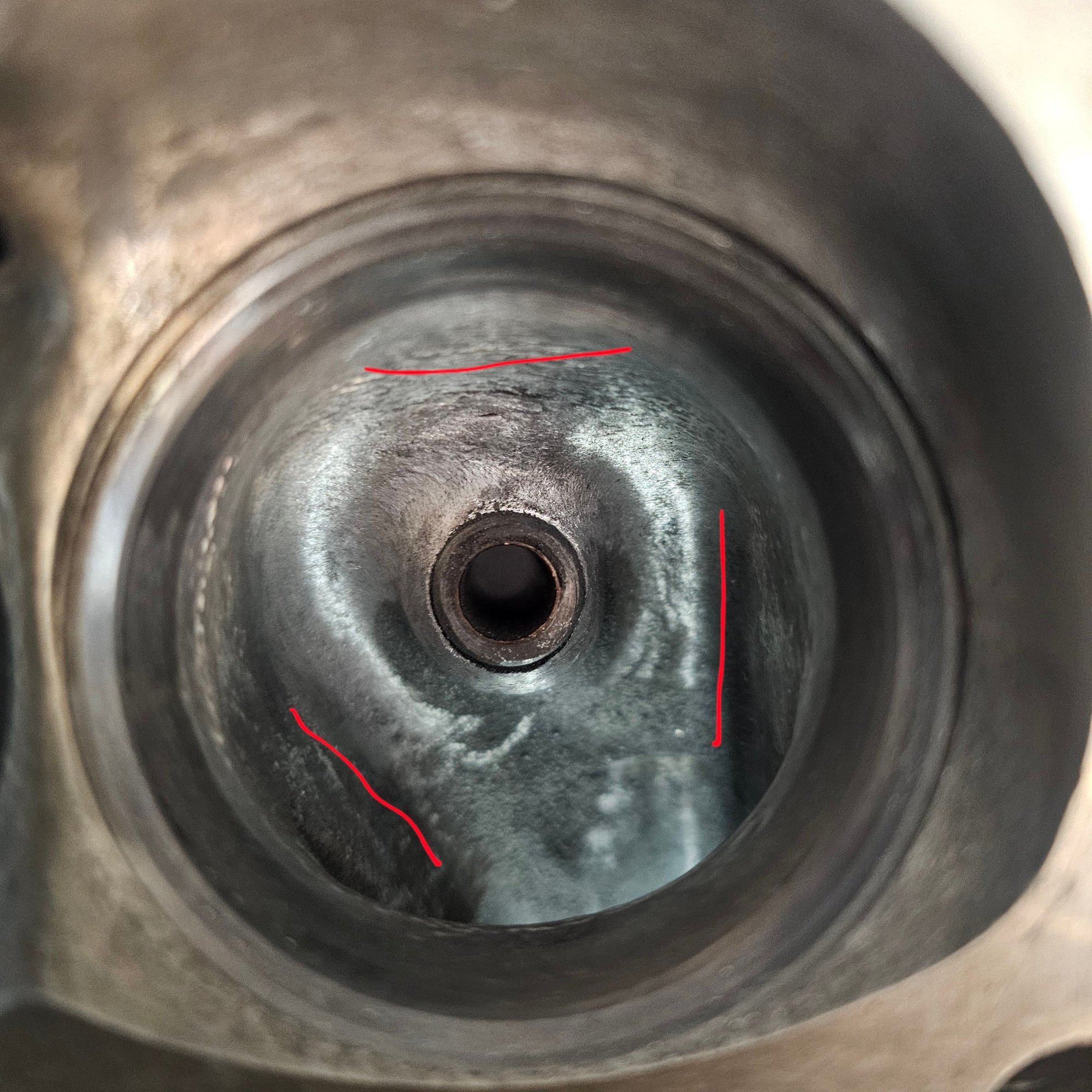 Pic 6: intake port doesnt open to the center of the bowl area. The right line shows the bowl nearly flush with the port. The left shows the bowl curve before meeting the port. Should area near the left line be ground away so the port centerline matches bowl centerline? Or does this offcenter design promote swirl? The bowl wall around the top line is closer to the bowl centerpoint than the wall on the left or right side. Should that be ground so centerpoint to wall distance is equal all around? 