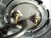 Is that tight? Or do the nut tabs bend and lock into the tank tabs?