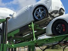 You know what's cool?  Watching the driver of the car hauler unload your brand spanking new Stingray off the truck!  It's like Christmas morning with your present still wrapped!