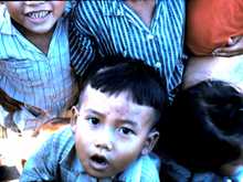 The victims of war, happy to get our excess C rations - like candy to them.