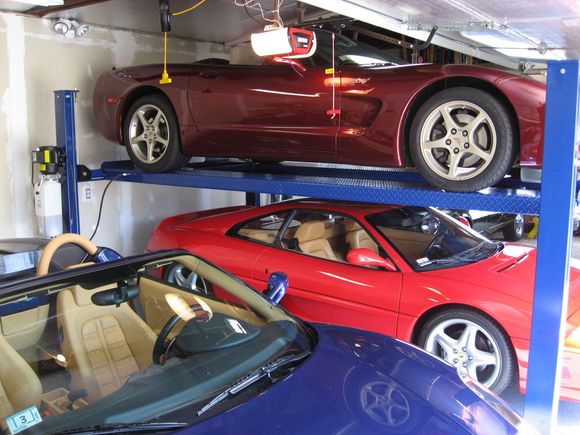 The height to the opened garage door over the top car is 8 1/2 feet.
