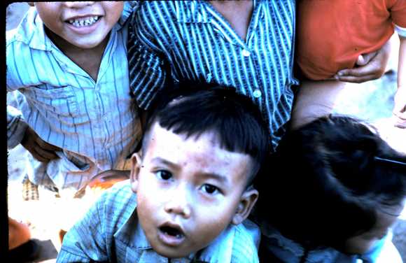 The victims of war, happy to get our excess C rations - like candy to them.
