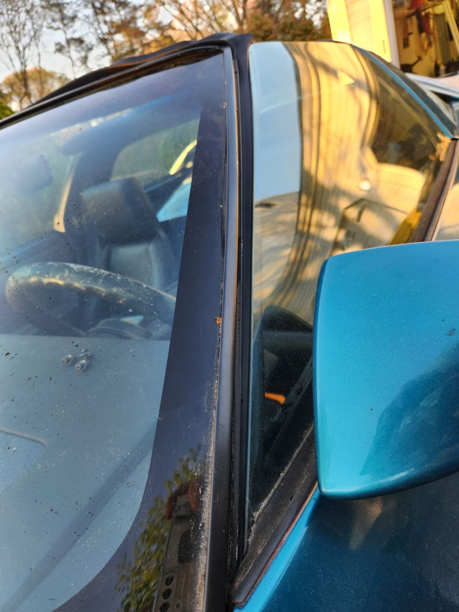 1986 How to secure loose windshield trim, twists when door closes