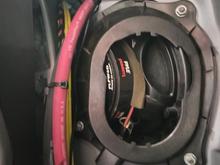 There is a small hole through the bulkhead near the right subwoofer.  There is a sound insulation piece that needs to come out, but it fits back in when done.  