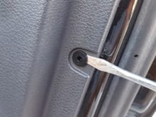 Next, use a flat blade screwdriver or something similar to gently pry the fasteners that hold the door panel to the door.