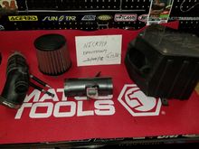 AEM Intake. It's in good shape. Includes the factory intake pipe. The filter has a small wear spot on it, shown in the picture below. Also, the cover on the intake box has a stripped screw and it cannot be removed, but the cover itself can still be removed with the screw still in place. 

Im asking $150 plus shipping. 
