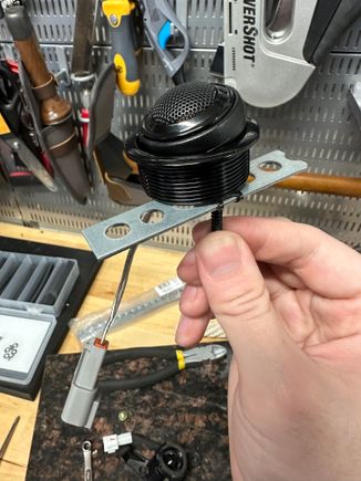 New tweeter in plastic housing and homemade mounting bracket. I had to cut the long black screw protruding beneath