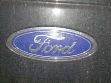 Dirty tailgate Ford emblem.