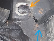 I lengthened the hole for lower radiator bushing toward the support about 2 inches. The blue arrow points to the tangs i flattened,leave the 2 tangs closest to the support up To keep condenser rubber in place against bottom of support.