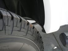 Cut White plastic fender edge for tire clearance