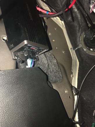 Amp mounted under drives side dash where the door parking break would be.