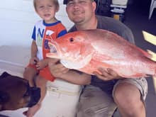 Nice red snapper they caught Saturday...they limit out everytime on these. Only 2 per person and you can catch 2 in 10 minutes at the rigs about 15 miles offshore. Even the dog is admiring the catch!