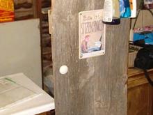 front door, made from old barn wood at about 3:30A.M.
The sign is from Germany. It says &quot;please sit while you pee&quot;