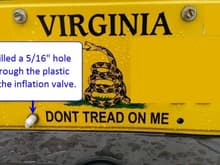 Air bag inflation valve license plate