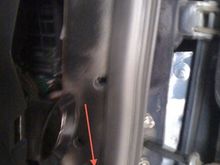 the bottom gold screw on the passenger side
