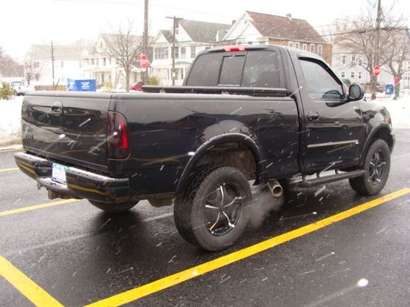 Tailpipe exit in front of tire