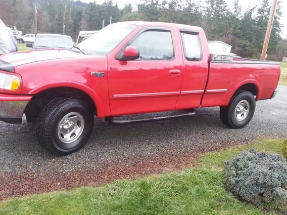 Truck with new tires, nerf bars, and tool box