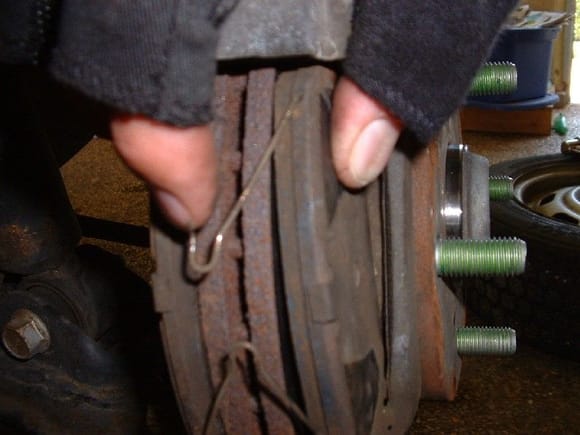 Shown here, but covered by the caliper when installed - credit to some fingerless glove wearing guy i found via google image search.