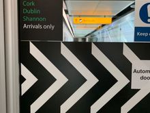Door with a sign reading “Cork Dublin Shannon Arrivals only”