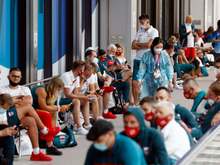 Poland’s team wait for COVID-19 testing upon arrival in Tokyo.Credit: