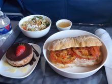 
PTY-ATL 
chicken sandwich with a salad and desert that was pretty good. Sandwich was not particularly flavorful. 

Other choices were Salmon Salad and Pasta. My neighbor got the pasta, it did not look appetizing. 
In any case glad my route had hot meals both ways.